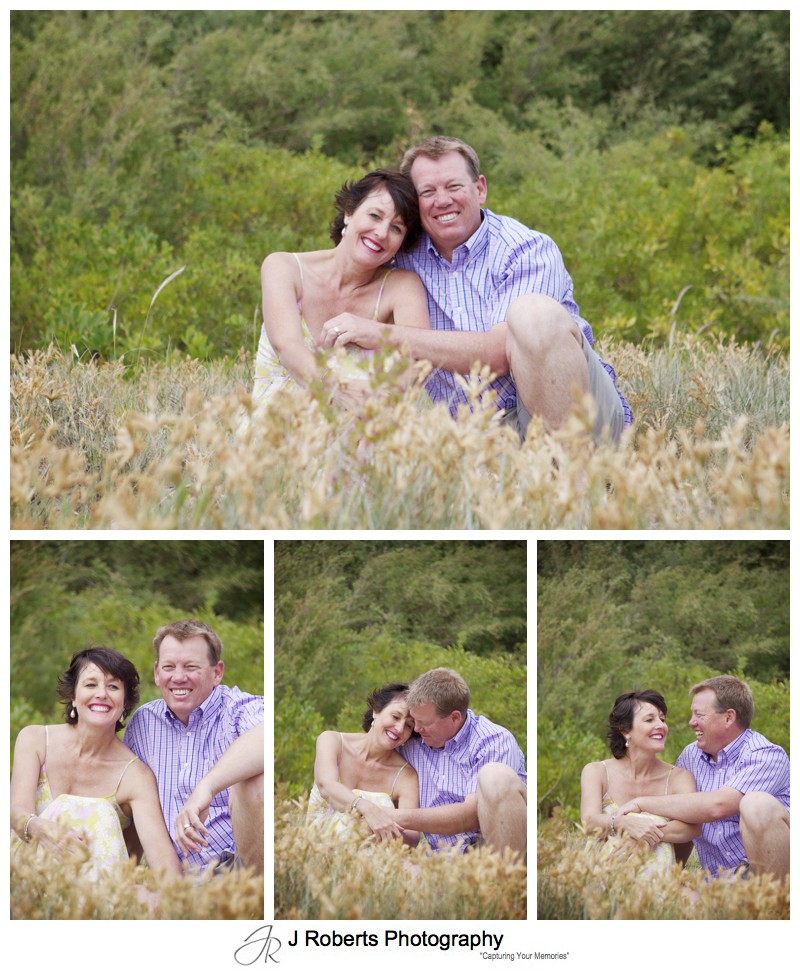 Laughing couple in sand dunes - sydney family portrait photography